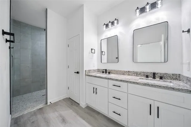 a bathroom with a double vanity sink and mirror
