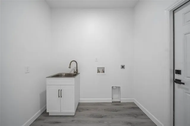 a view of a room with wooden floor