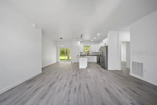 a view of kitchen with cabinets wooden floor and outdoor space