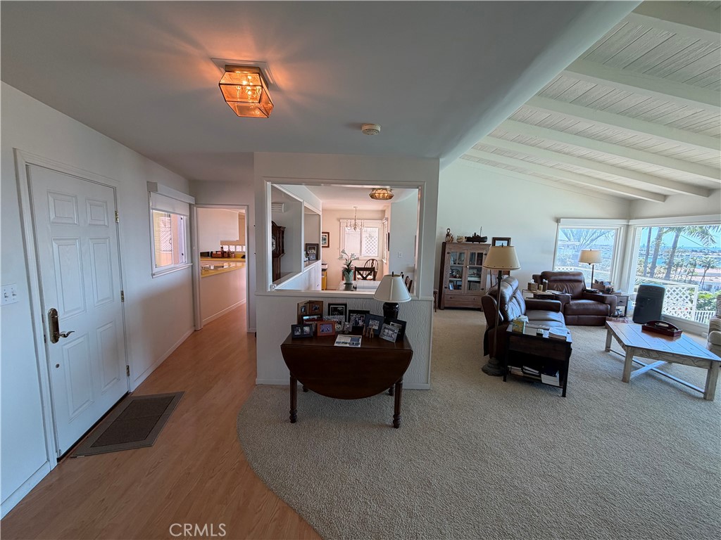 1221 Kings Road Newport Beach, CA 92663 - Photo 13 of 14 a living room with furniture and a chandelier