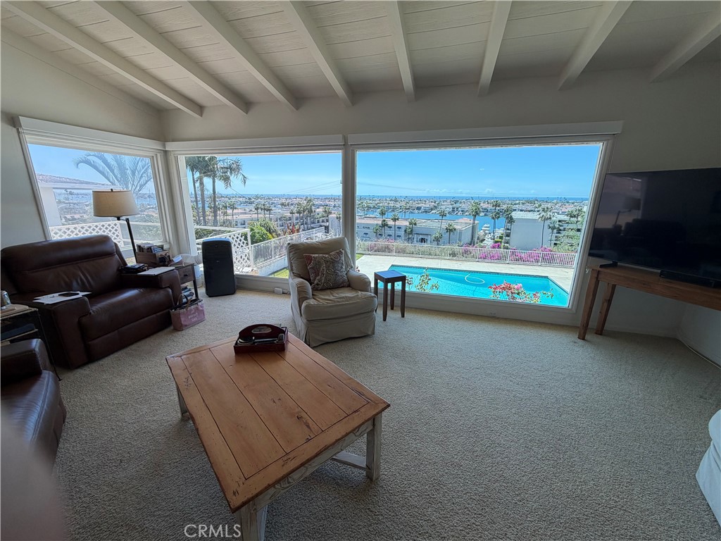 1221 Kings Road Newport Beach, CA 92663 - Photo 14 of 14 a living room with furniture and a flat screen tv