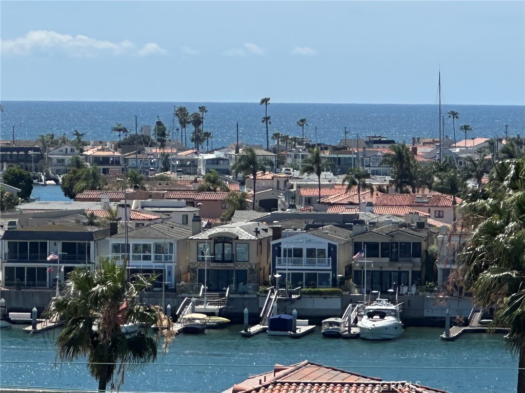 1221 Kings Road Newport Beach, CA 92663 - Photo 10 of 14 a city street filled with lots of traffic and parked cars