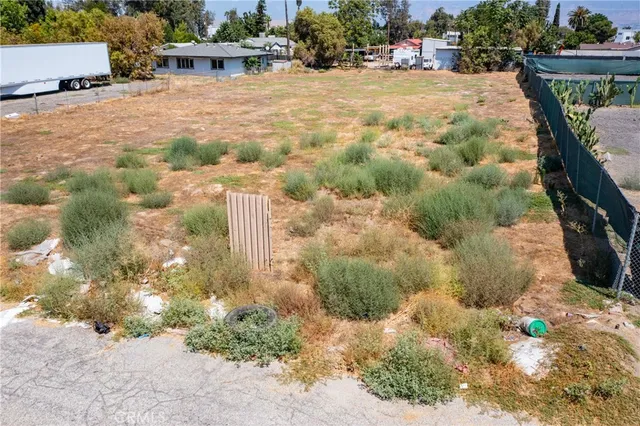 an aerial view of a house with a yard and parking spaces