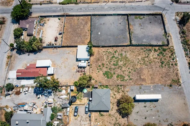 an aerial view of a house with a yard and parking spaces
