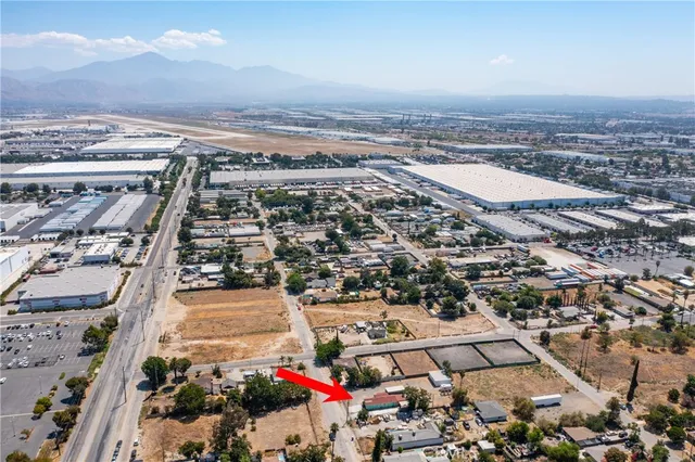 an aerial view of multiple houses with yard