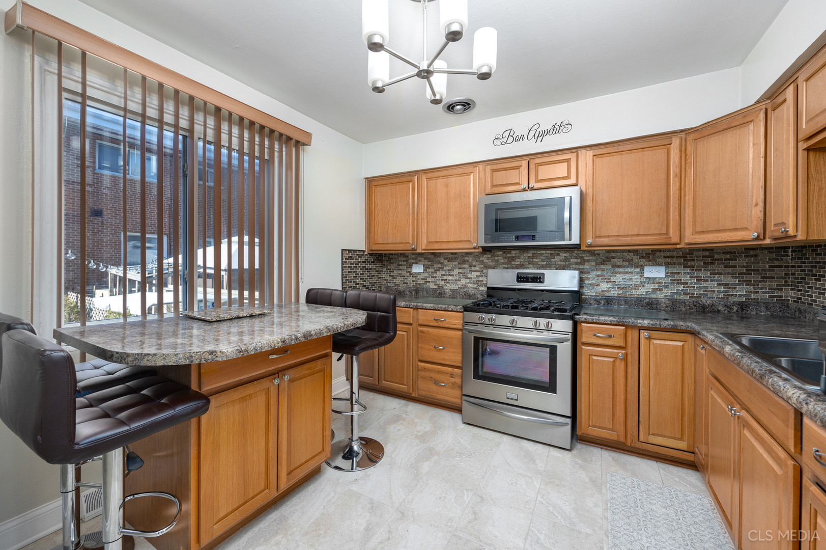 20 North Albert Street Mount Prospect, IL 60056 - Photo 5 of 25 a kitchen with stainless steel appliances granite countertop a stove a sink dishwasher and a microwave oven with cabinets