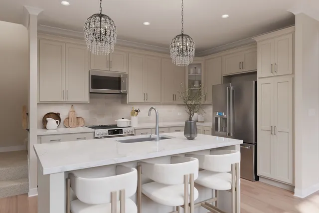 a kitchen with stainless steel appliances a table chairs refrigerator and cabinets