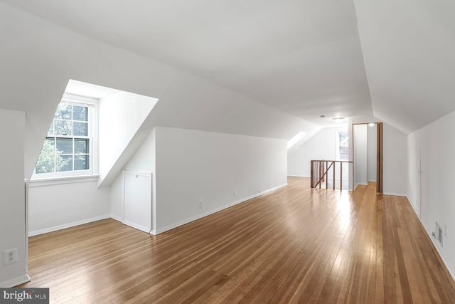 a view of staircase with wooden floor and a window