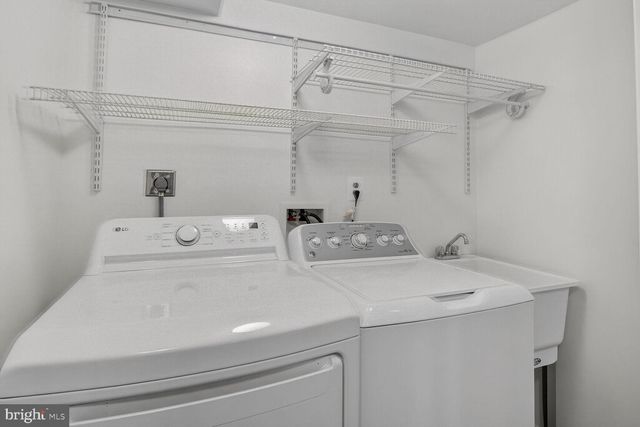 a view of a balcony with chairs and a potted plant