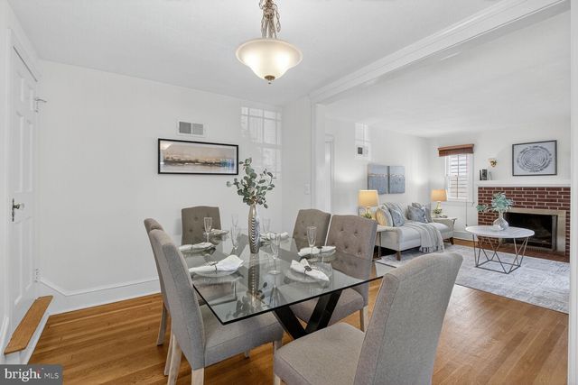 a view of a dining room with furniture wooden floor and chandelier