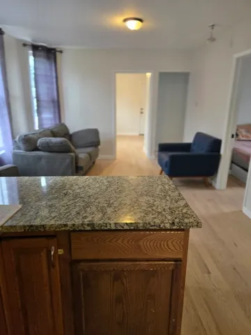 a large bathroom with a granite countertop sink and a mirror