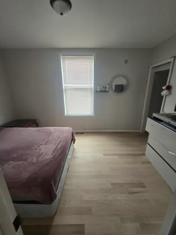 a view of a room with wooden floor and windows
