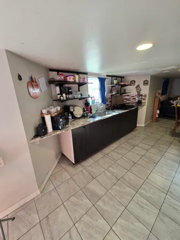 a kitchen with stainless steel appliances a stove a sink and a refrigerator