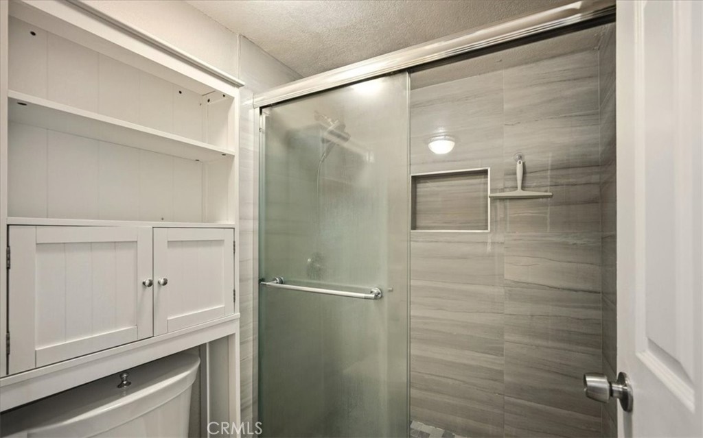 1200 West Lambert Road La Habra, CA 90631 - Photo 20 of 37 a bathroom with a glass shower door