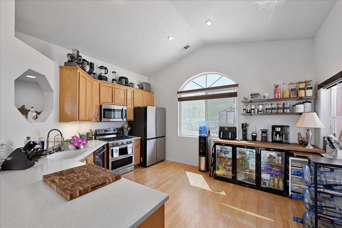 7497 McCourtney Road Lincoln, CA 95648 - Photo 11 of 73 a kitchen with stainless steel appliances a stove a sink and a refrigerator