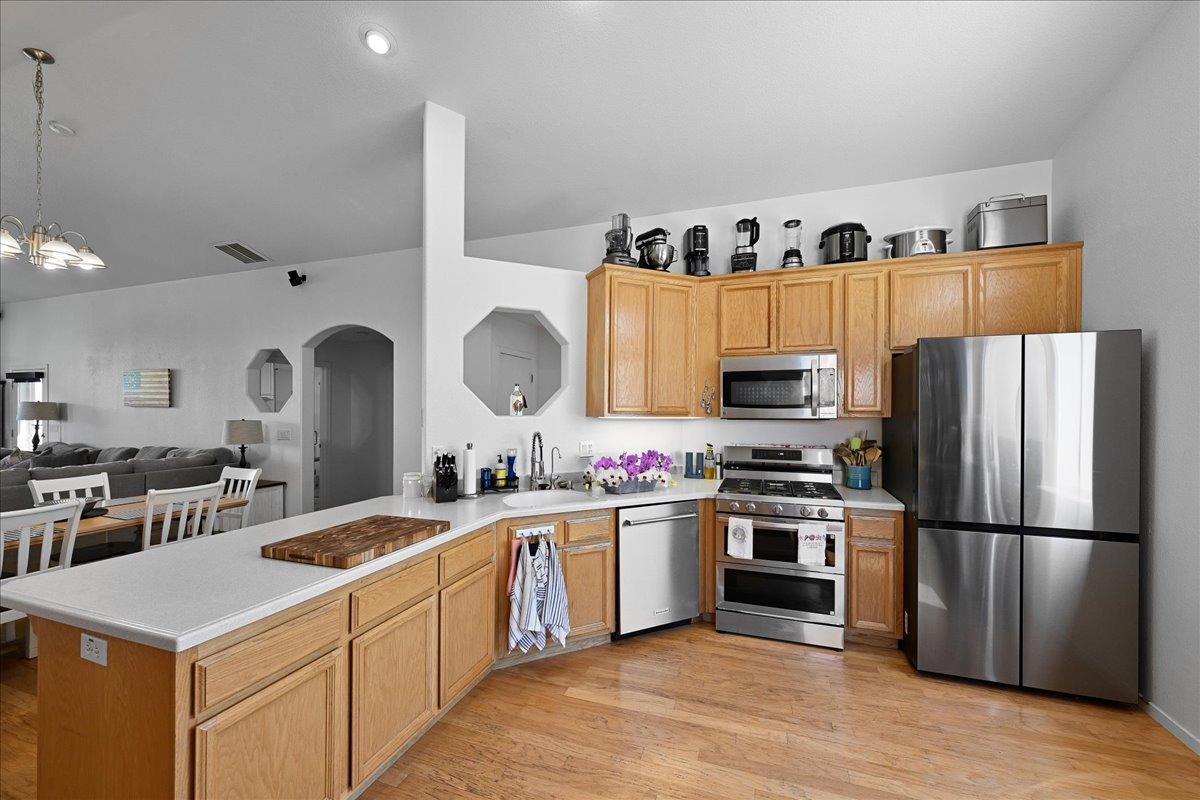 7497 McCourtney Road Lincoln, CA 95648 - Photo 12 of 73 a kitchen with granite countertop a sink stainless steel appliances and white cabinets