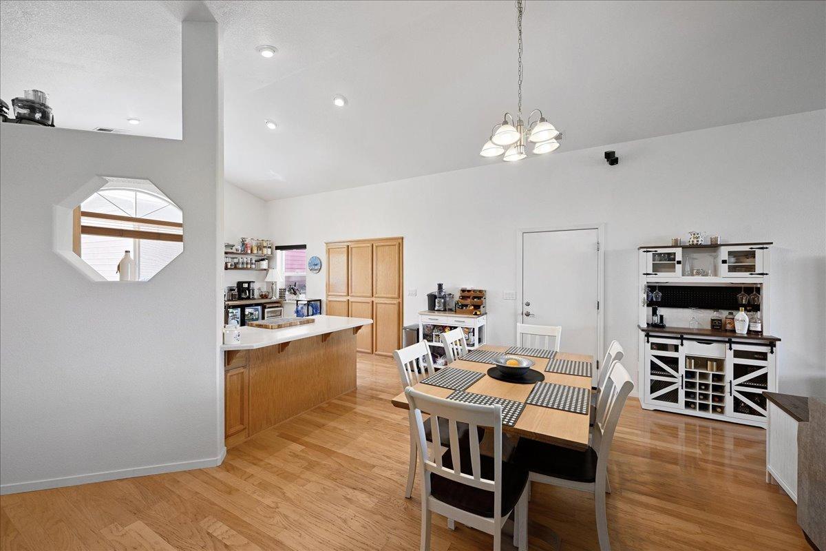 7497 McCourtney Road Lincoln, CA 95648 - Photo 19 of 73 a view of a dining room with furniture wooden floor and chandelier