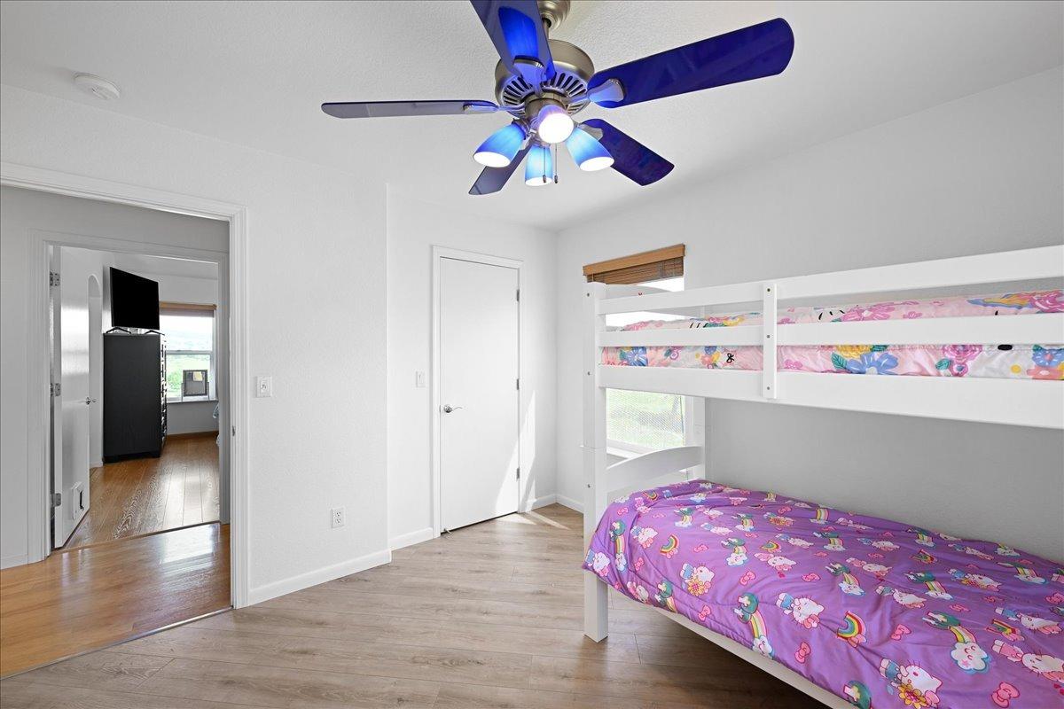 7497 McCourtney Road Lincoln, CA 95648 - Photo 30 of 73 a bedroom with a bed and a chandelier