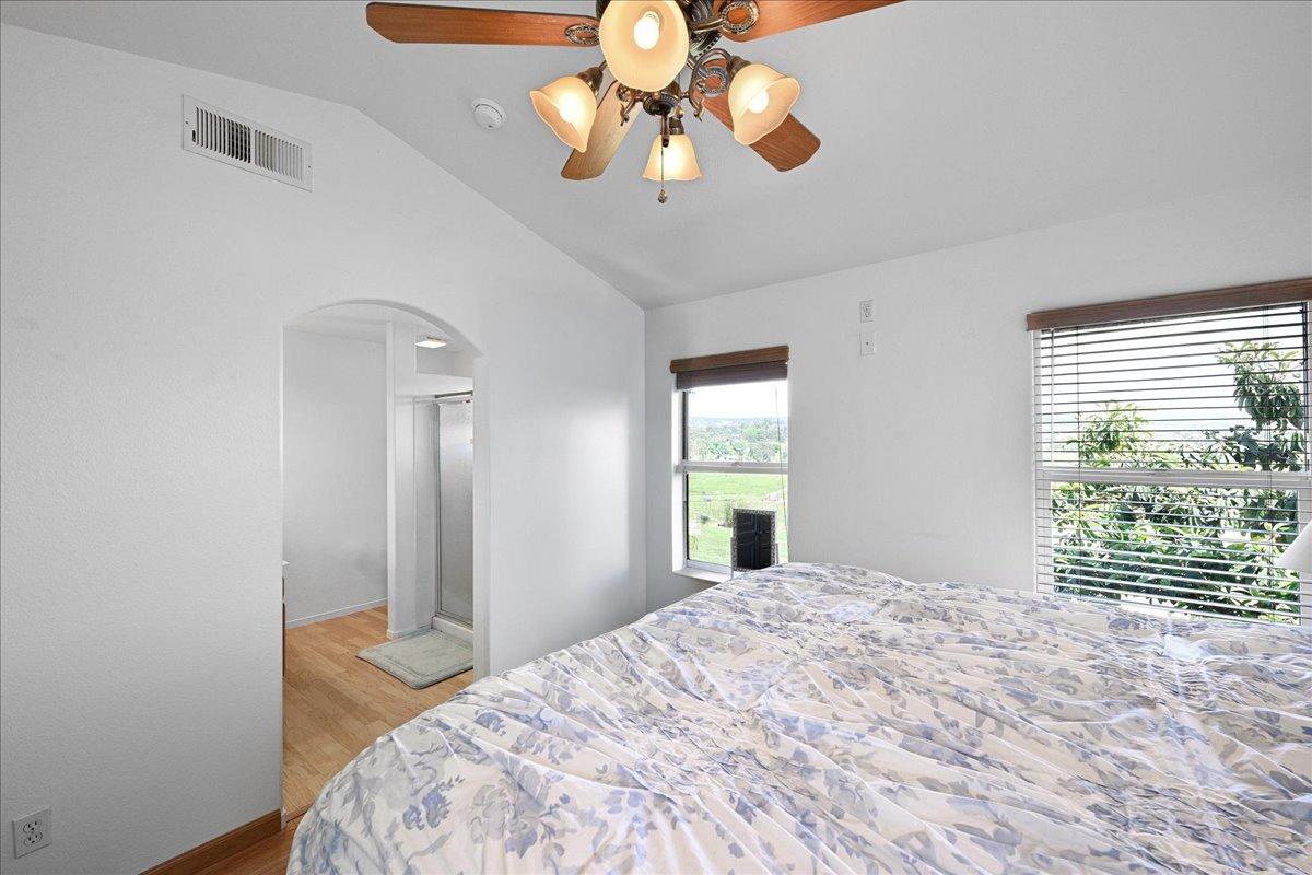 7497 McCourtney Road Lincoln, CA 95648 - Photo 32 of 73 a bedroom with a bed and a chandelier