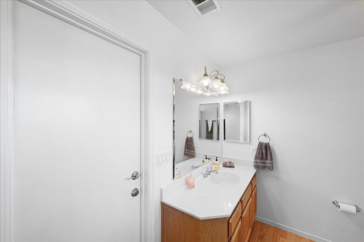 7497 McCourtney Road Lincoln, CA 95648 - Photo 34 of 73 a bathroom with a sink a mirror and vanity