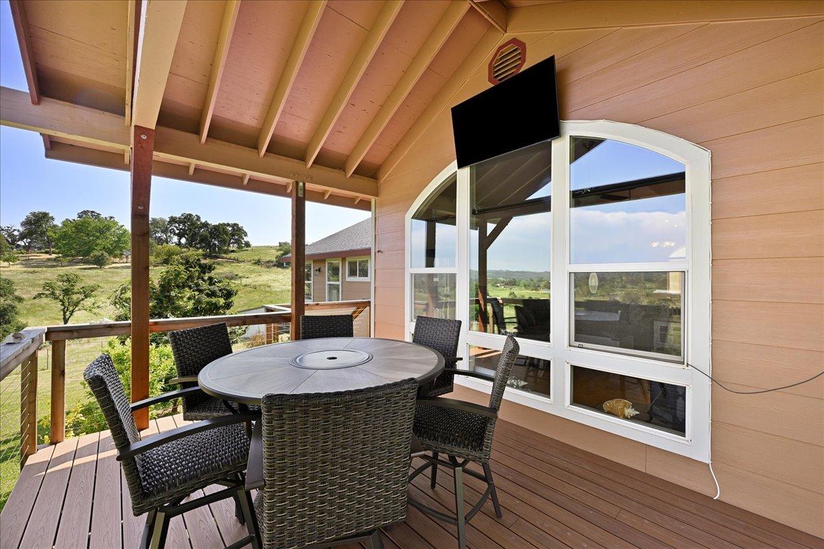 7497 McCourtney Road Lincoln, CA 95648 - Photo 38 of 73 a view of a patio with a table chairs and wooden floor