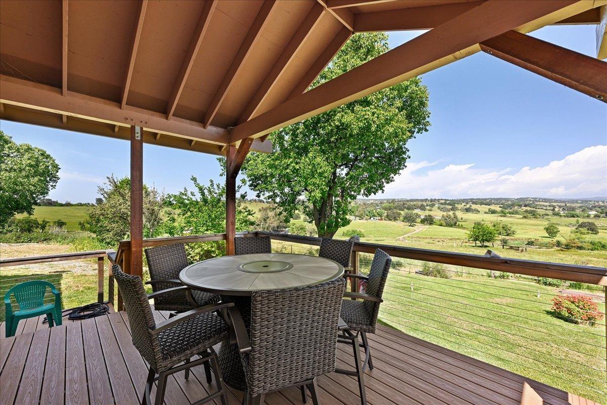 7497 McCourtney Road Lincoln, CA 95648 - Photo 39 of 73 a view of a patio with table and chairs and wooden floor
