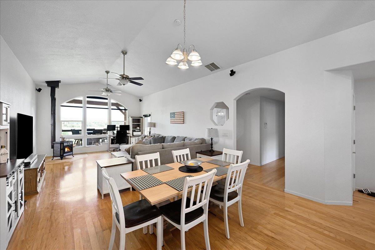 7497 McCourtney Road Lincoln, CA 95648 - Photo 9 of 73 a view of a dining room with furniture a chandelier and wooden floor