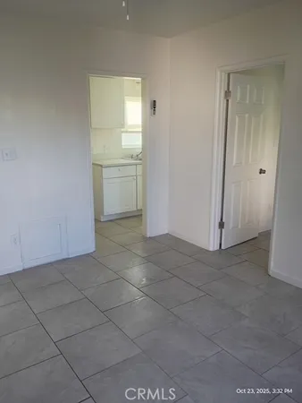 a view of a kitchen cabinets and empty room