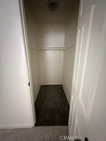 a view of a closet with wooden floor