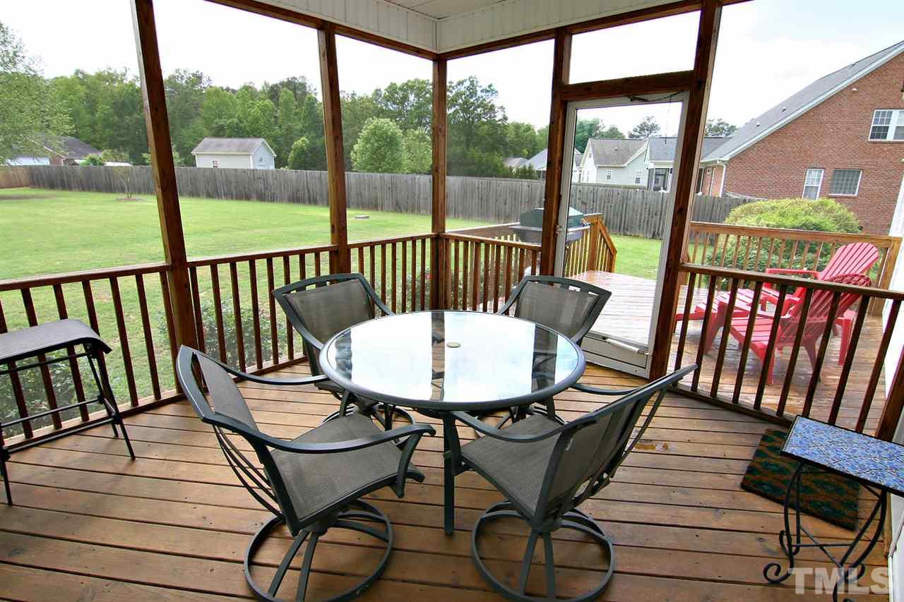 1720 Shell Cracker Drive Willow Spring, NC 27592 - Photo 2 of 10 a view of a two chairs and table on the deck