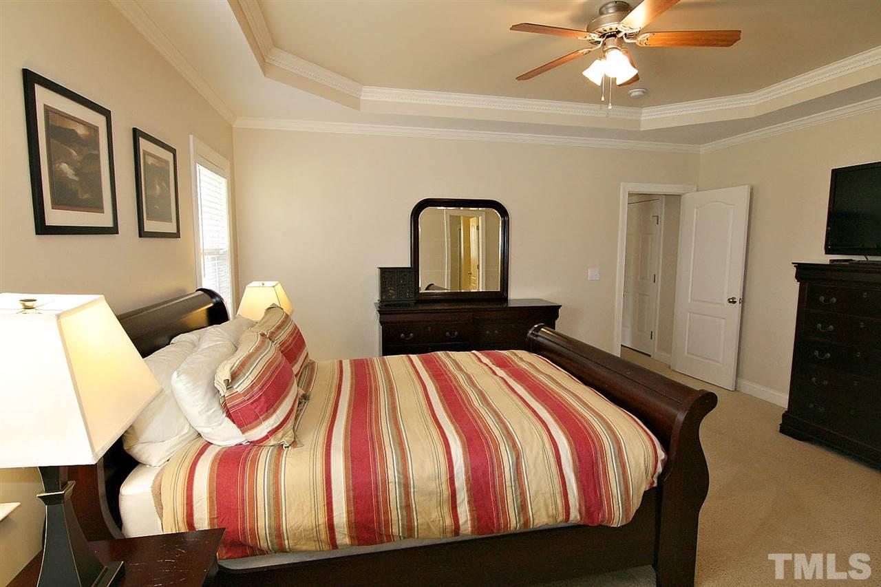 1720 Shell Cracker Drive Willow Spring, NC 27592 - Photo 5 of 10 a bedroom with a bed and dresser with mirror
