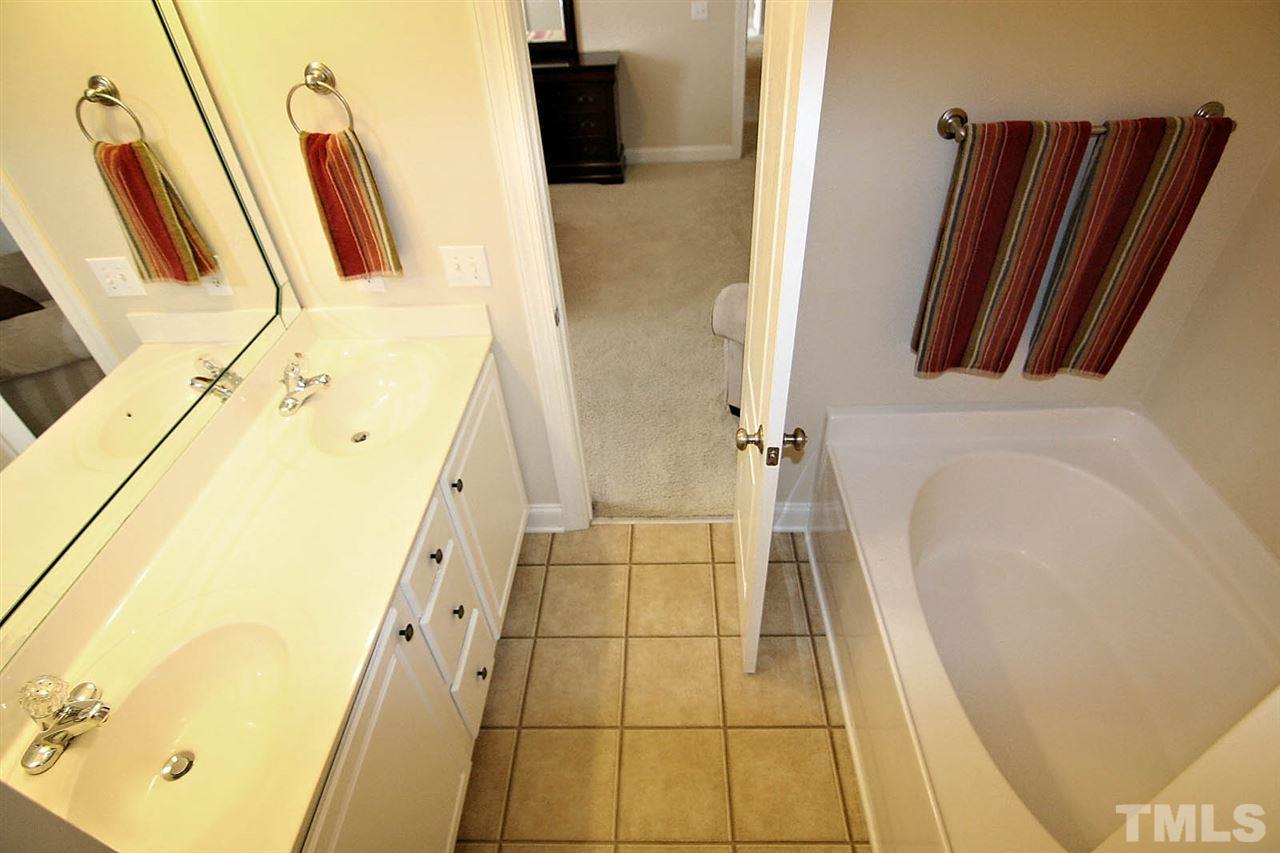 1720 Shell Cracker Drive Willow Spring, NC 27592 - Photo 7 of 10 a bathroom with a sink a toilet a mirror and shower