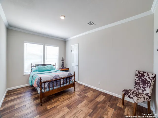 a room with a bed window and wooden floor