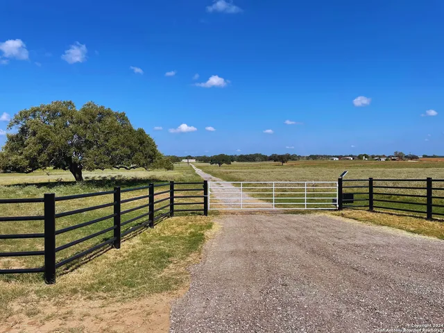 a view of outdoor space with wooden deck and a bench