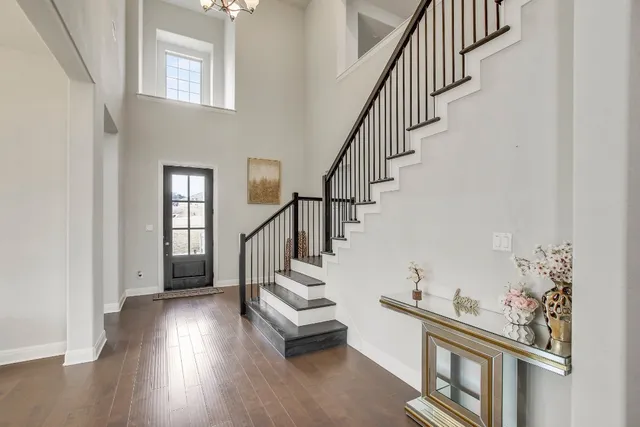 a view of entryway and hall with wooden floor