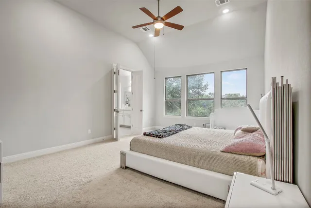 a bedroom with a bed and large window