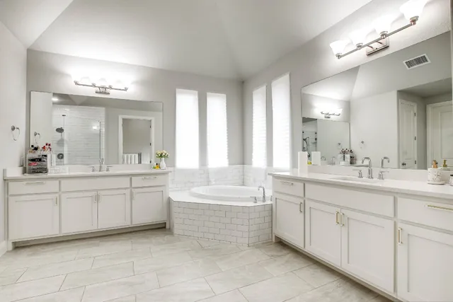 a bathroom with a sink mirror and a bathtub