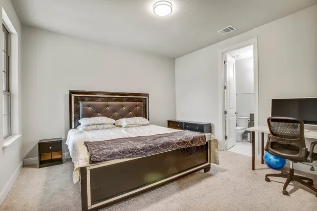 a bedroom with a bed and a chair