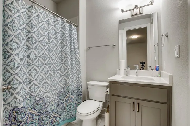 a bathroom with a sink toilet and mirror