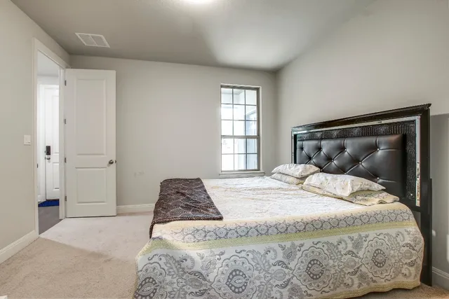 a bedroom with a bed and window