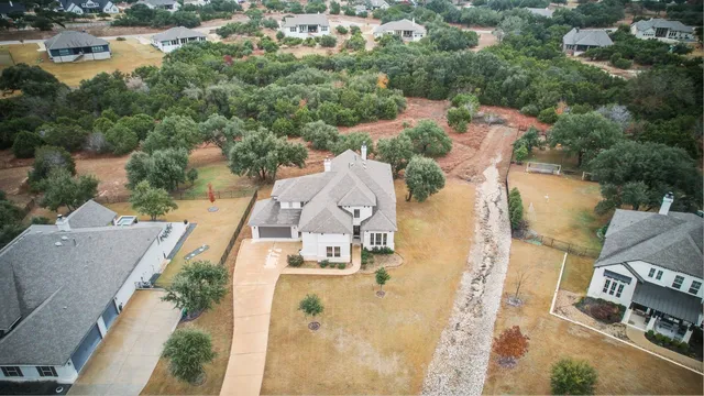 an aerial view of a house with outdoor space and lake view