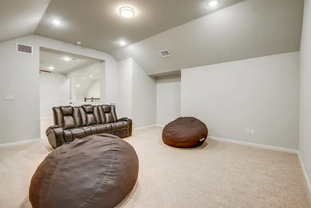 a living room with furniture and a mirror