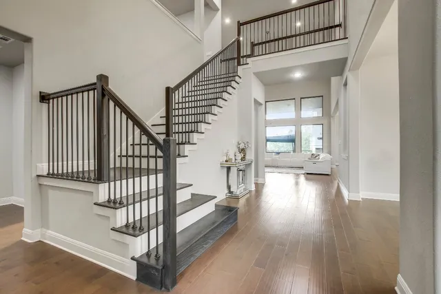 a view of staircase with white walls and a window