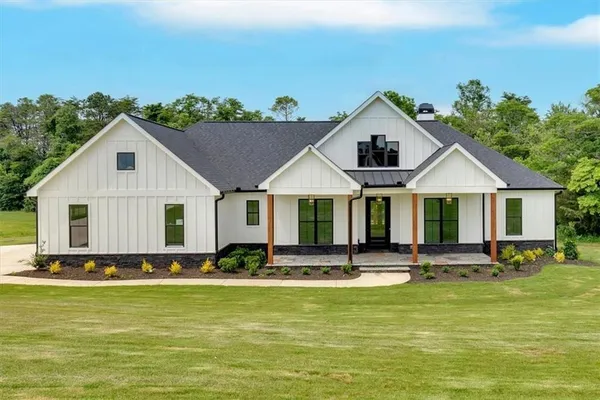 a front view of house with yard and outdoor seating