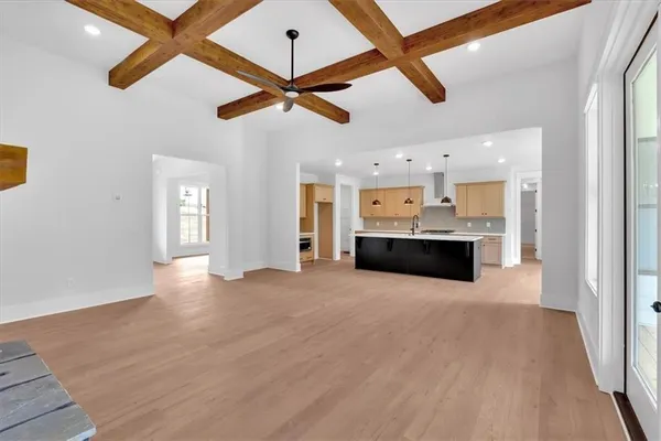 a view of a kitchen with a sink and a chandelier fan