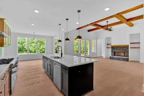 a kitchen with stainless steel appliances granite countertop a stove and a sink