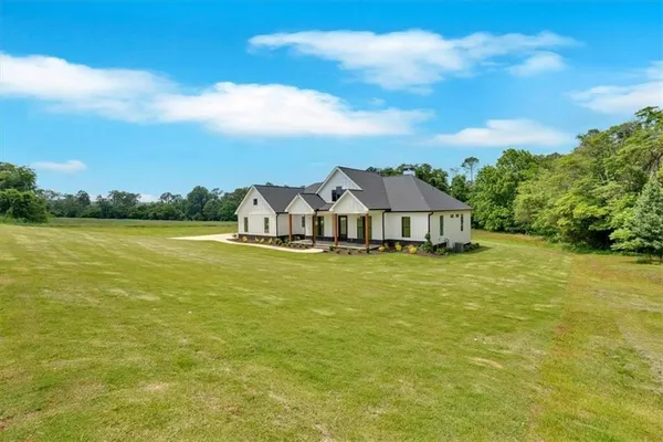 a front view of a house with a big yard