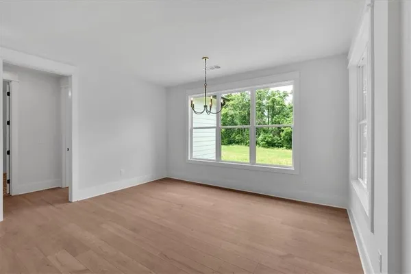 an empty room with windows and outdoor view