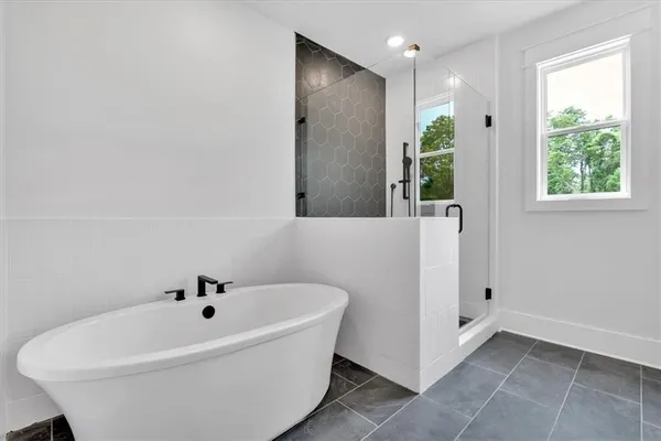 a white bath tub sitting in a bathroom