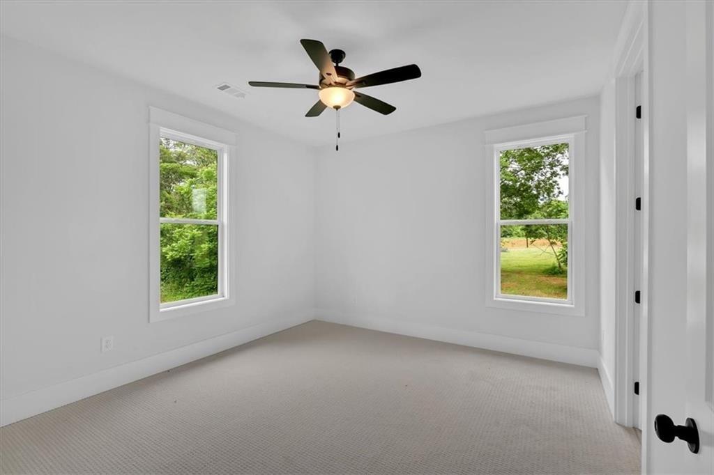 300 Eminence Peak Rydal, GA 30171 - Photo 35 of 46 an empty room with windows and ceiling fan